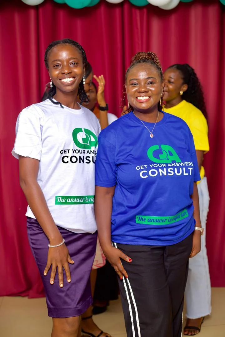Two women wearing blue shirts that say Get Your Answers Consult.