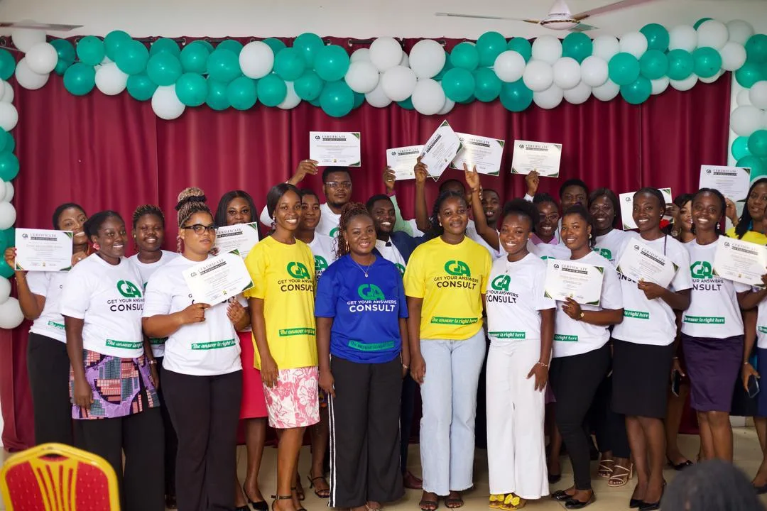 A group of people holding certificates for a consulting company.